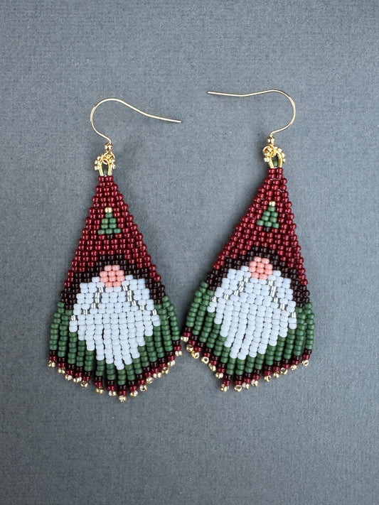 Hand-beaded fringe earrings with Santa gnome design in red, green, white, and gold with 24K gold-plated hooks