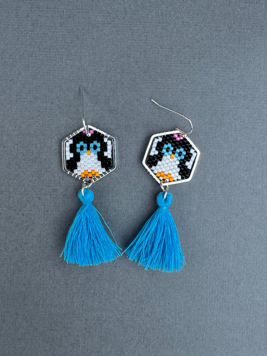 Hand-beaded penguin tassel earrings with blue cotton tassels and silver-plated hexagon frames